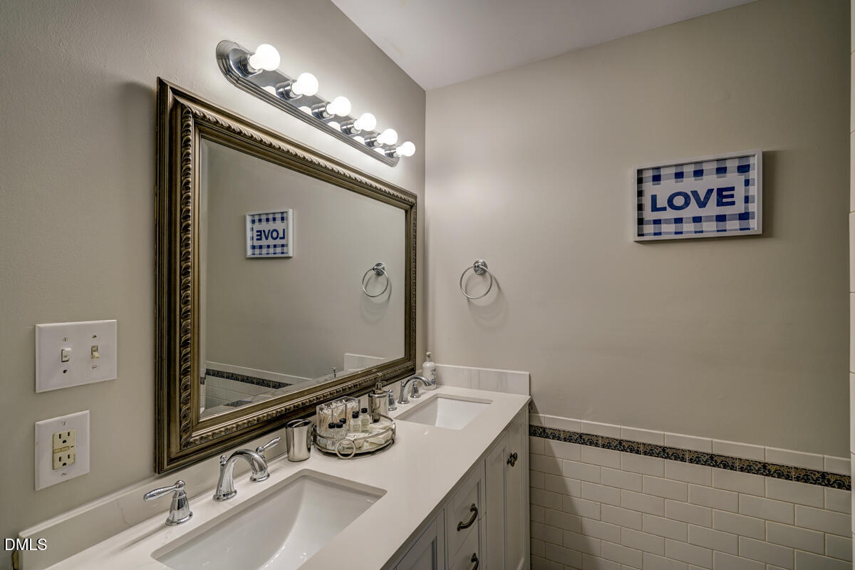 3418 Huntleigh Drive Raleigh, NC 27604 - Photo 43 of 55 a bathroom with a sink a mirror and a shower