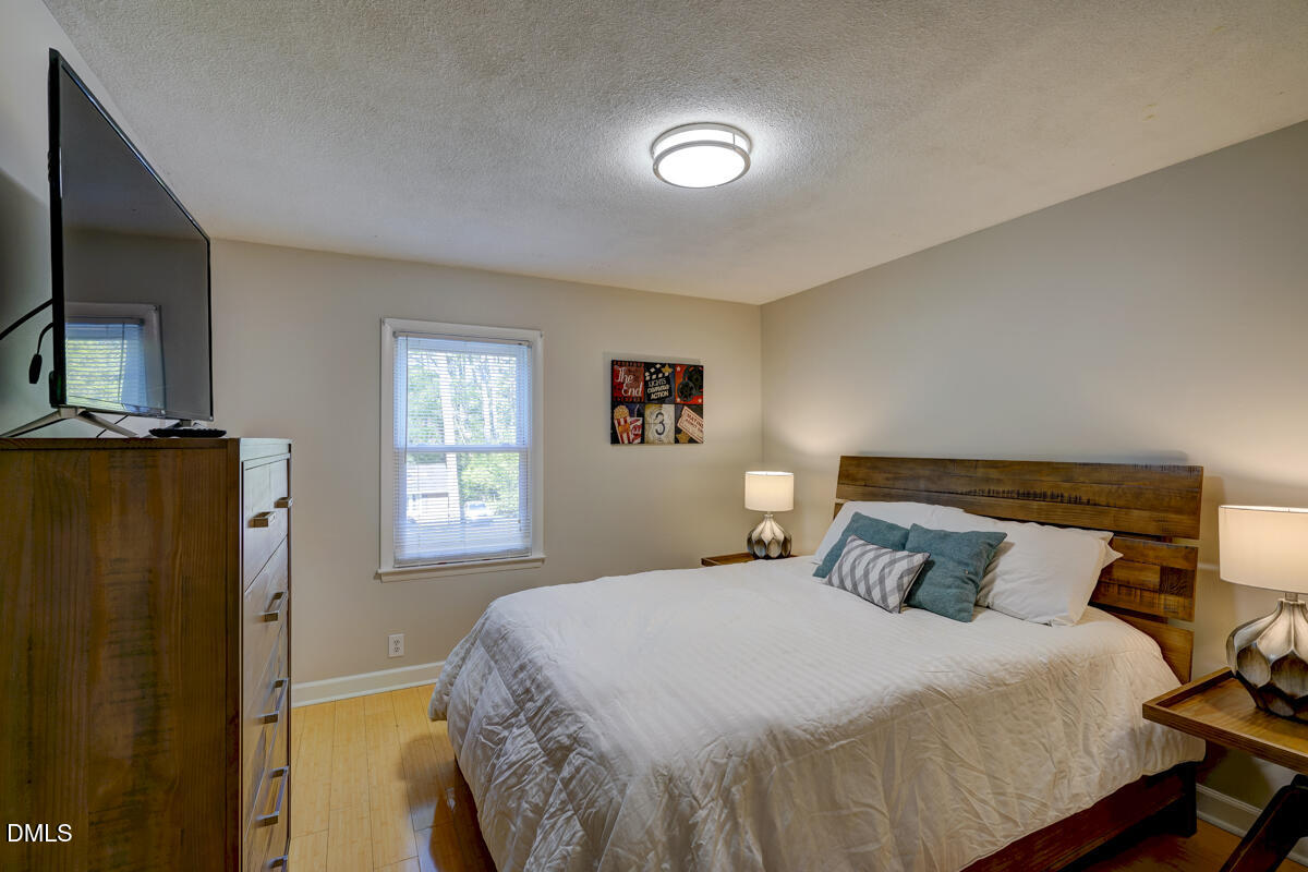 3418 Huntleigh Drive Raleigh, NC 27604 - Photo 47 of 55 a bedroom with a bed and a television