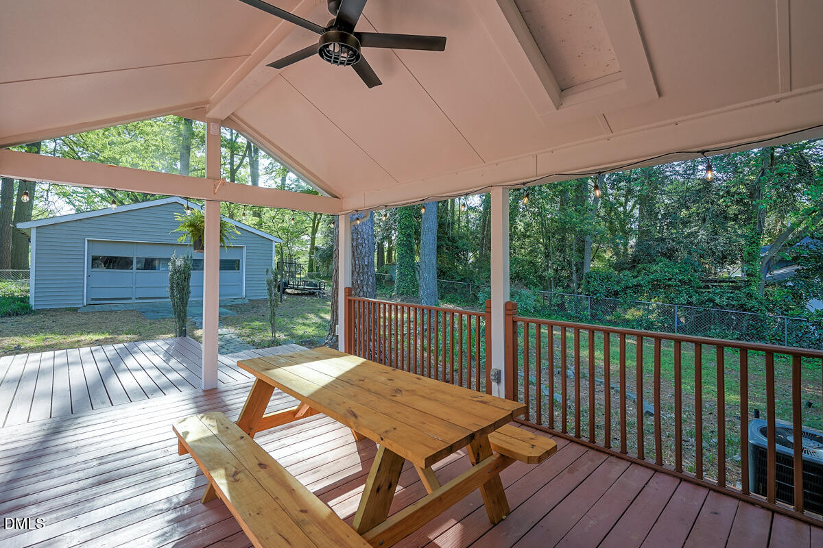 3418 Huntleigh Drive Raleigh, NC 27604 - Photo 54 of 55 a view of a patio with table and chairs under an umbrella