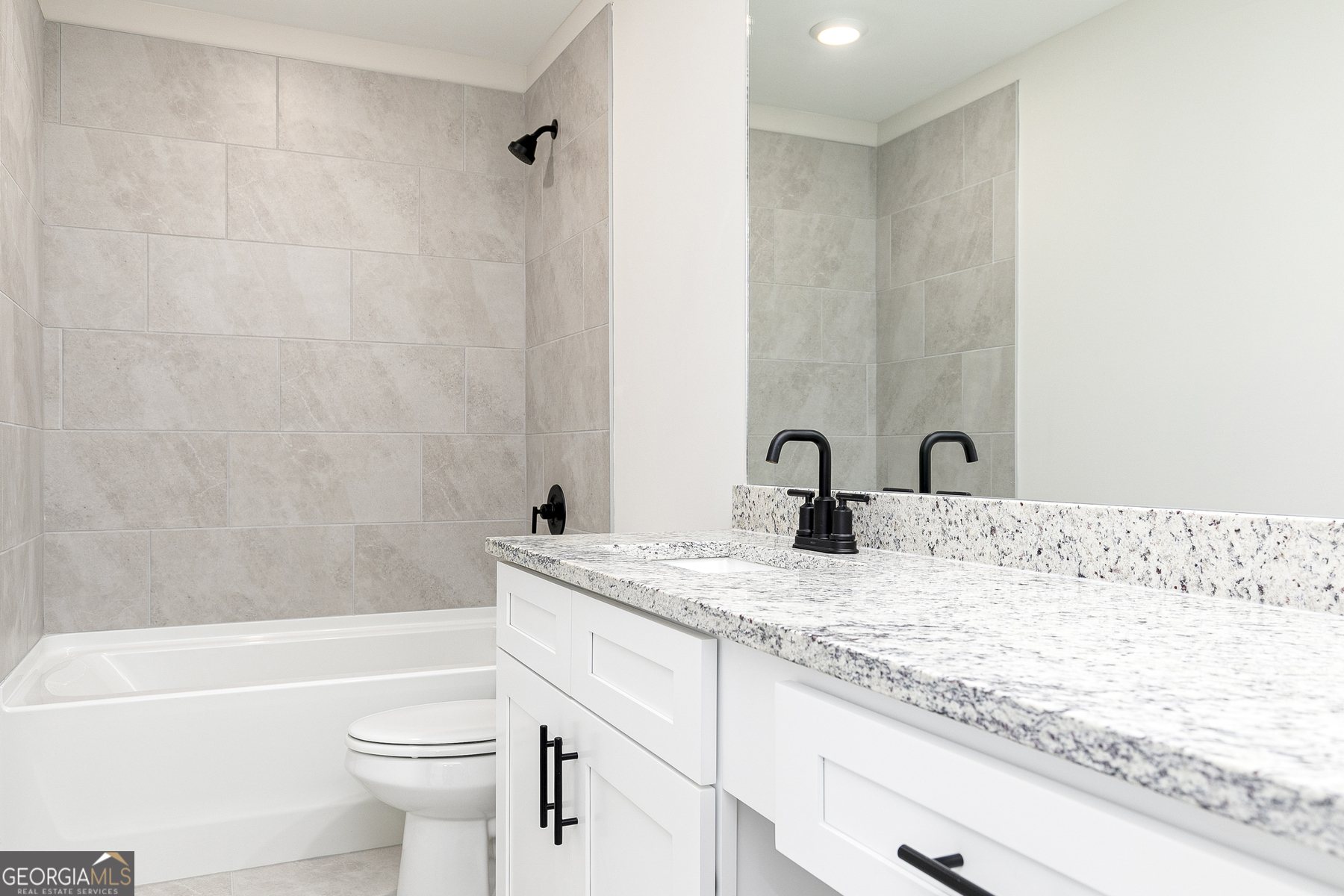 161 Sunfish Circle Hoschton, GA 30548 - Photo 12 of 13 a bathroom with a granite countertop sink a toilet and bathtub