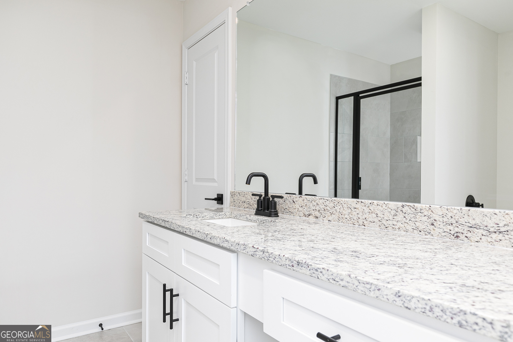 161 Sunfish Circle Hoschton, GA 30548 - Photo 8 of 13 a bathroom with a granite countertop sink and white cabinets
