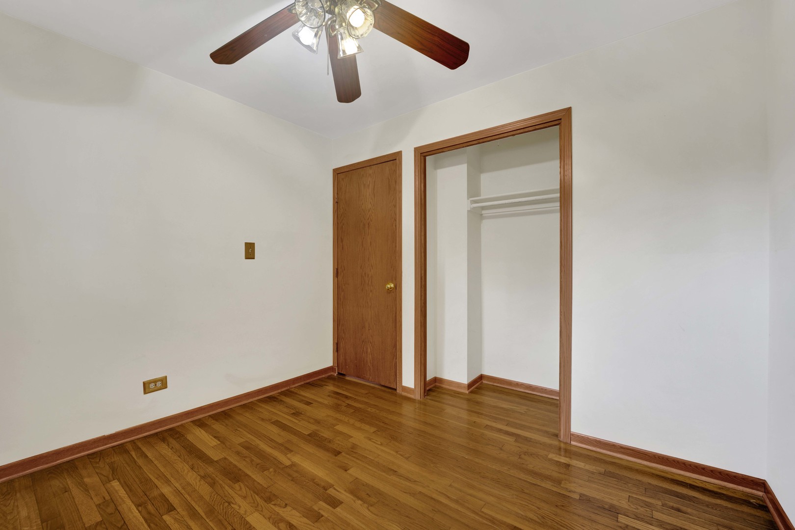 2S224 Valley Road Lombard, IL 60148 - Photo 23 of 37 an empty room with wooden floor and ceiling fan