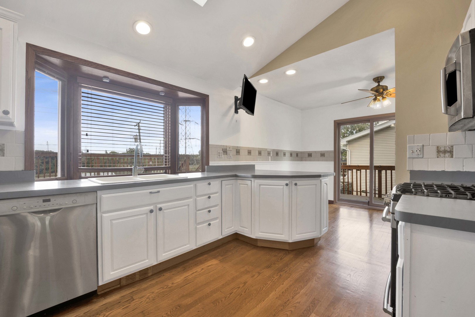 2S224 Valley Road Lombard, IL 60148 - Photo 5 of 37 a kitchen with granite countertop white cabinets and white appliances
