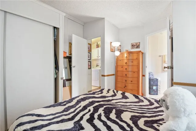 a bedroom with a bed and a closet