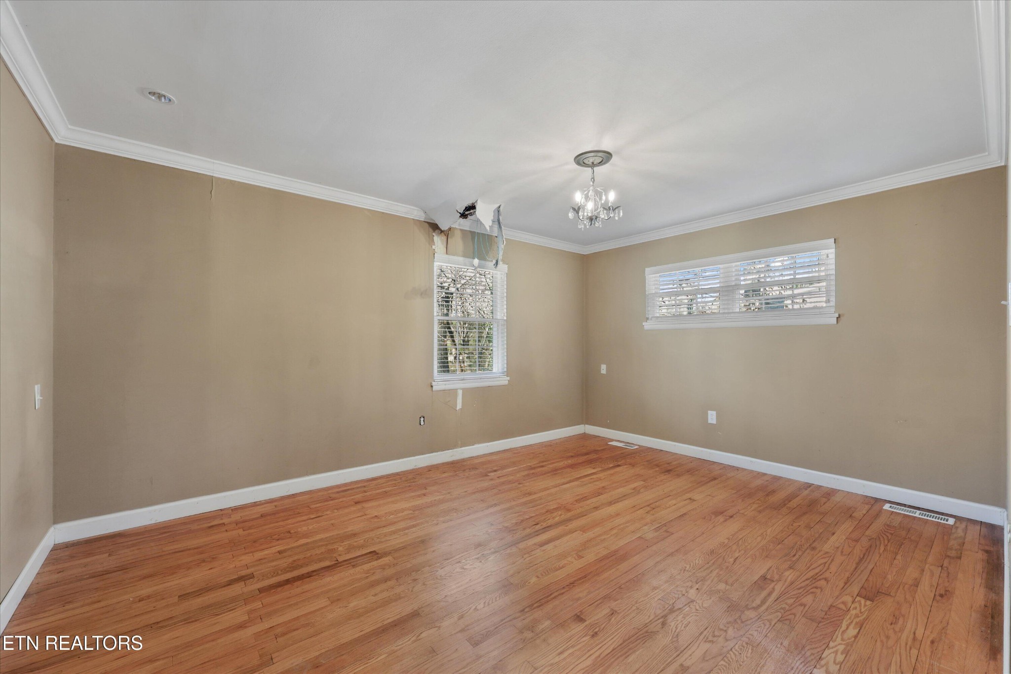 1221 Huntington Road Southwest Knoxville, TN 37919 - Photo 11 of 23 wooden floor in an empty room with a window