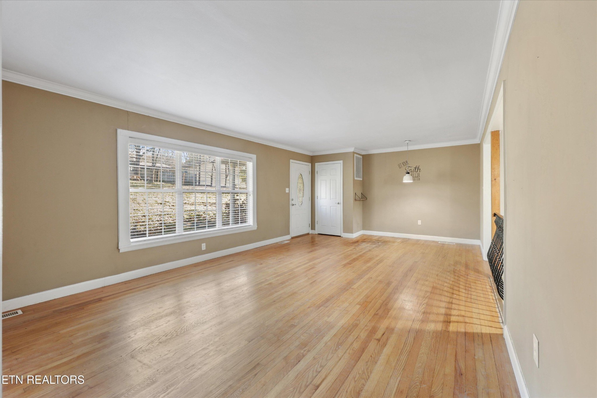 1221 Huntington Road Southwest Knoxville, TN 37919 - Photo 5 of 23 a view of an empty room with wooden floor and a window