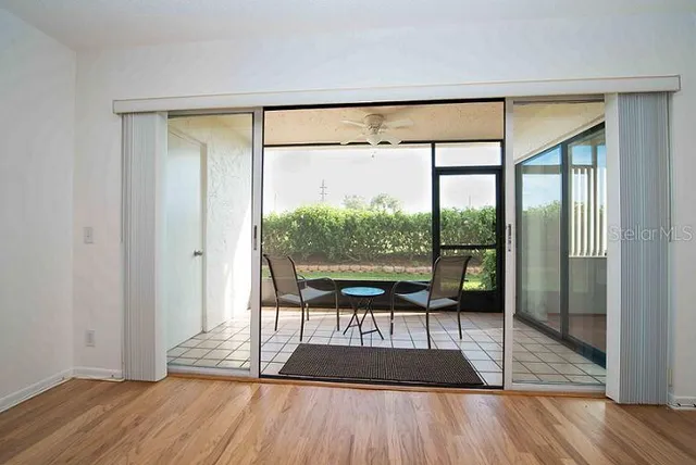 a view of a room with wooden floor and a window