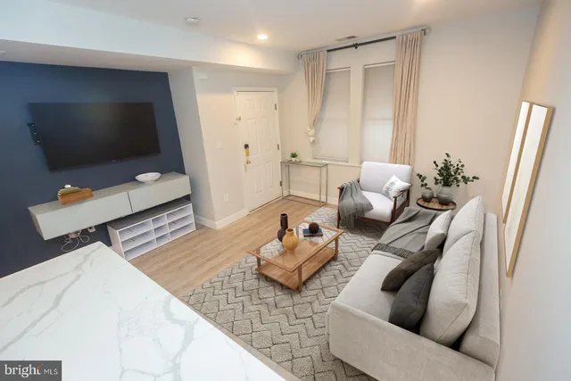 a living room with furniture and a flat screen tv