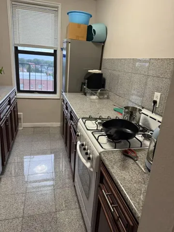 a stove top oven sitting inside of a kitchen
