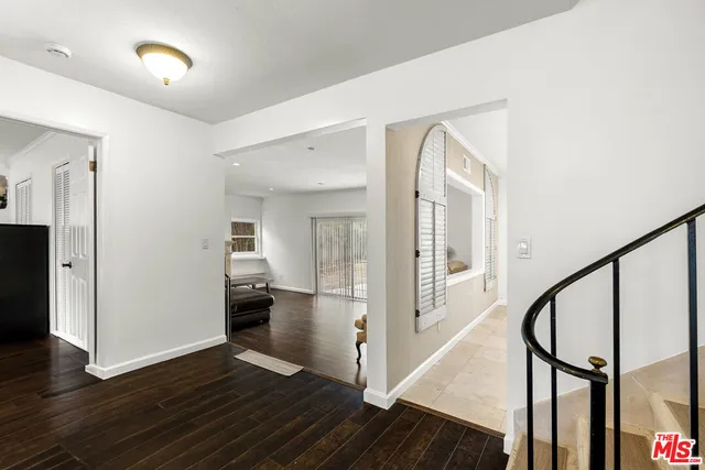 a view of a hallway view with wooden floor and staircase