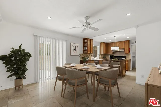 a view of a dining room with furniture and a potted plant