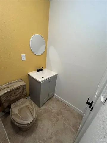 a bathroom with a sink toilet and a mirror