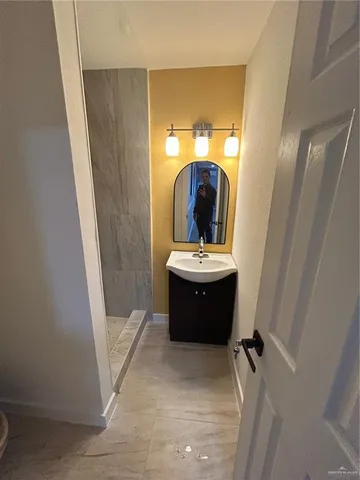 a view of living room with a sink and mirror