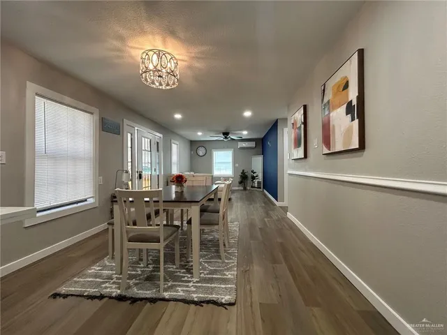 a view of a dining room with furniture and a chandelier