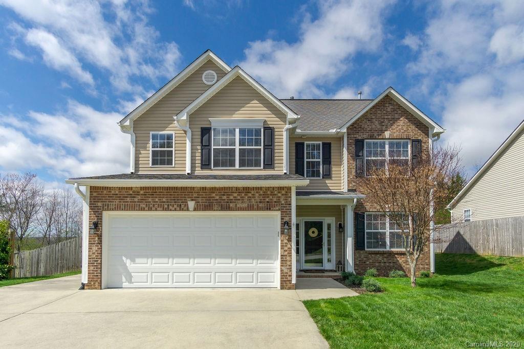 94 Wildbriar Road Fletcher, NC 28732 - Photo 1 of 27 a front view of a house with a yard and garage
