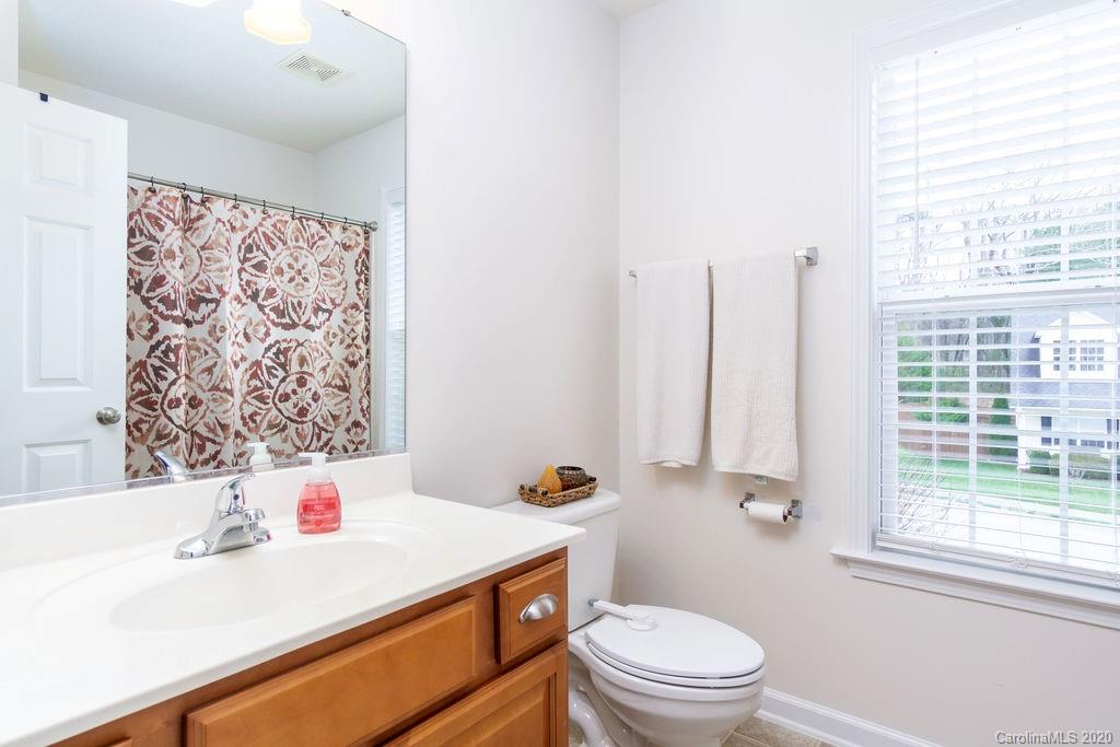94 Wildbriar Road Fletcher, NC 28732 - Photo 18 of 27 a bathroom with a sink a toilet and shower curtain
