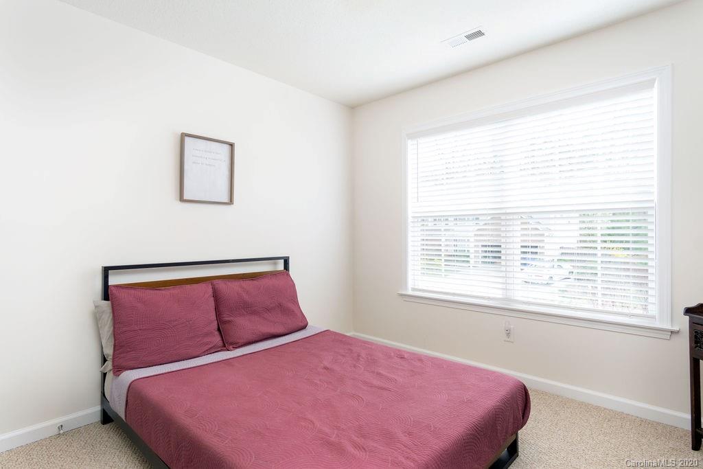 94 Wildbriar Road Fletcher, NC 28732 - Photo 19 of 27 a bedroom with a bed and a window