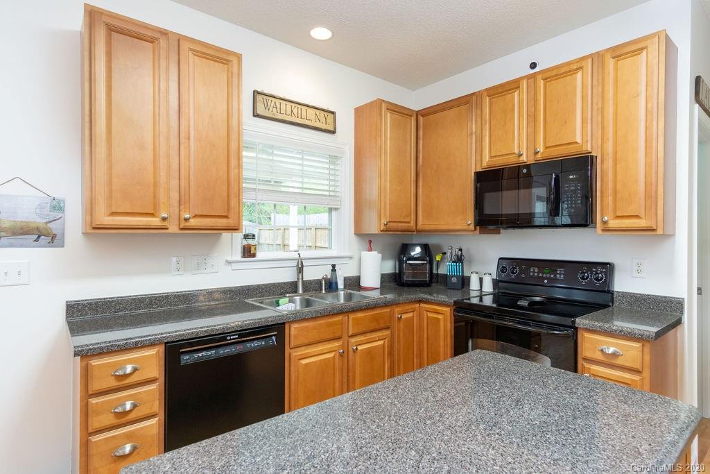 94 Wildbriar Road Fletcher, NC 28732 - Photo 6 of 27 a kitchen with stainless steel appliances granite countertop a stove a sink dishwasher and a microwave oven with cabinets