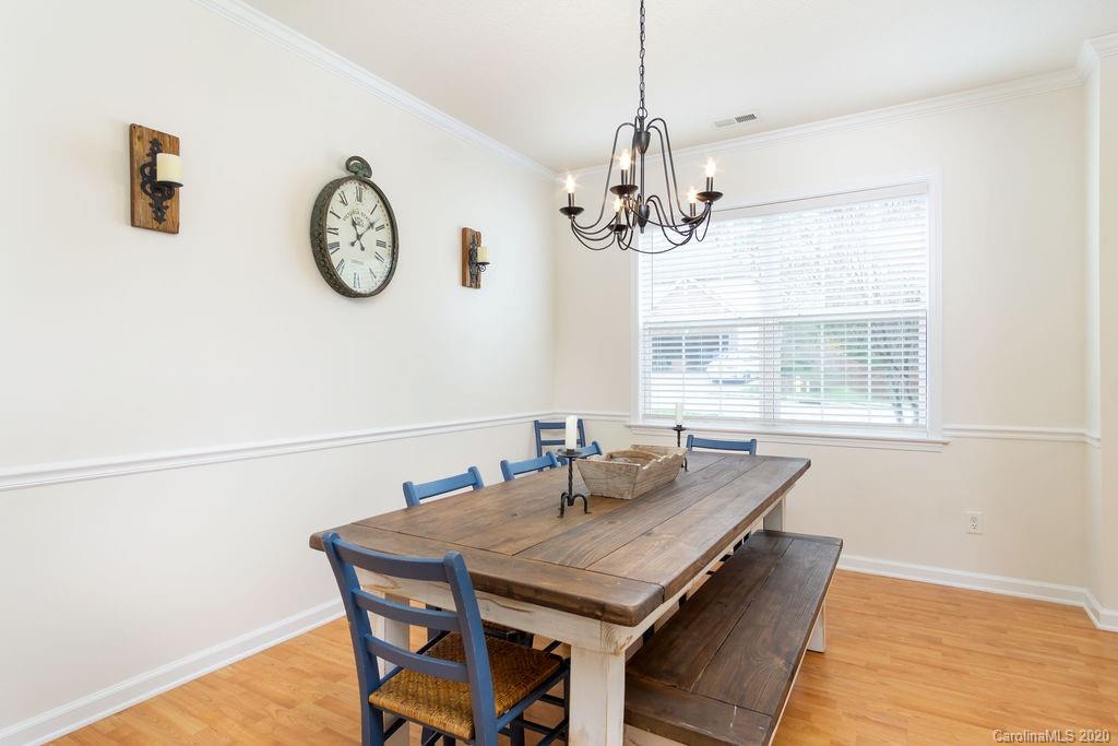 94 Wildbriar Road Fletcher, NC 28732 - Photo 9 of 27 a view of a dining room with furniture a chandelier and wooden floor