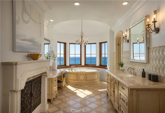 a spacious bathroom with a granite countertop sink mirror and a bathtub