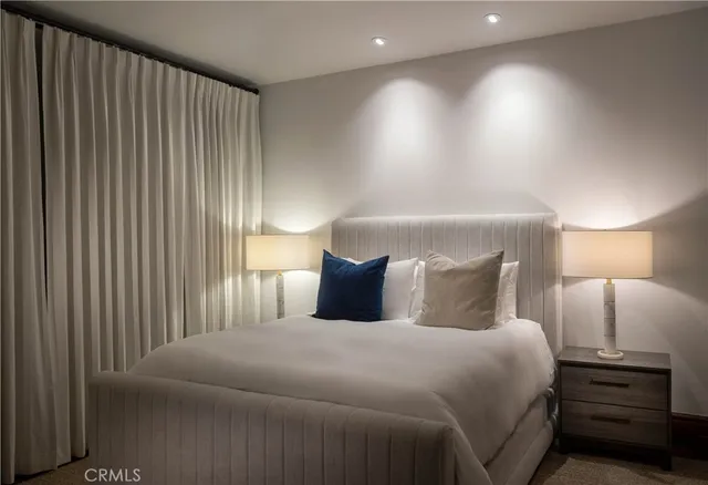 a bedroom with a bed and a night stand