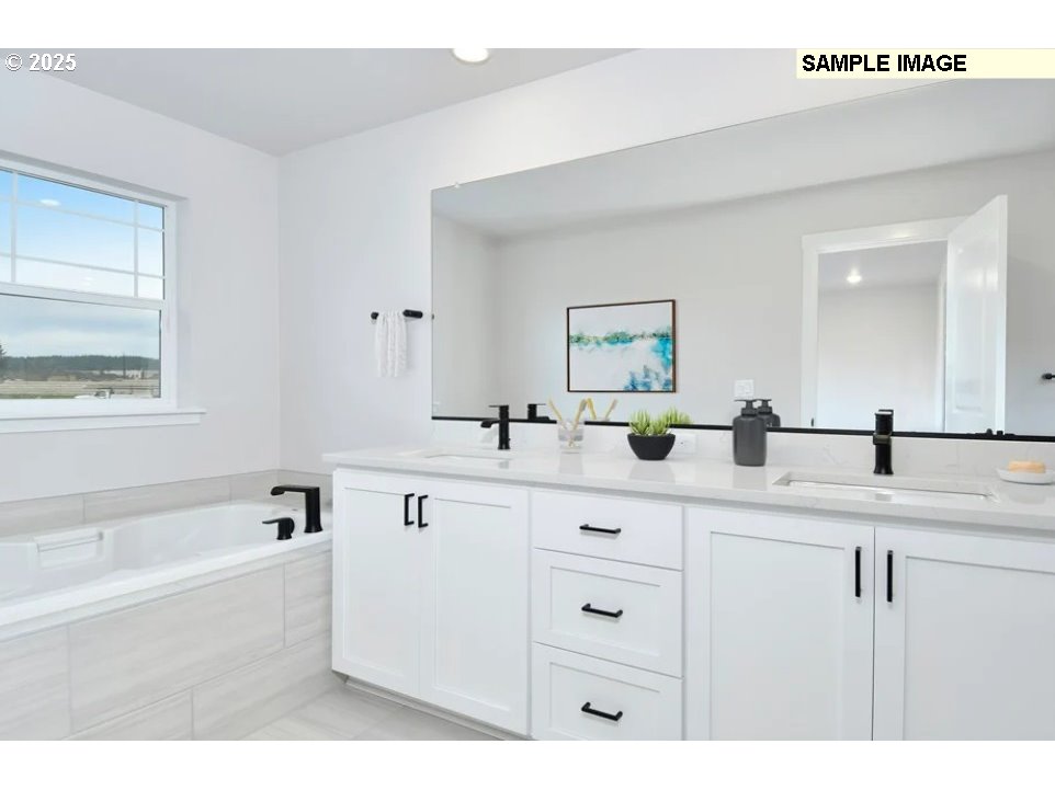 16782 Southwest Perth Road Tigard, OR 97224 - Photo 7 of 13 a spacious bathroom with a double vanity sink mirror and bathtub