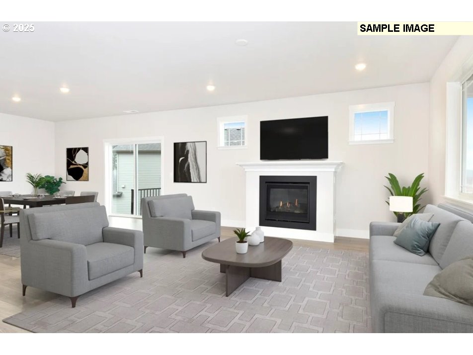 16782 Southwest Perth Road Tigard, OR 97224 - Photo 8 of 13 a living room with furniture a flat screen tv and a fireplace