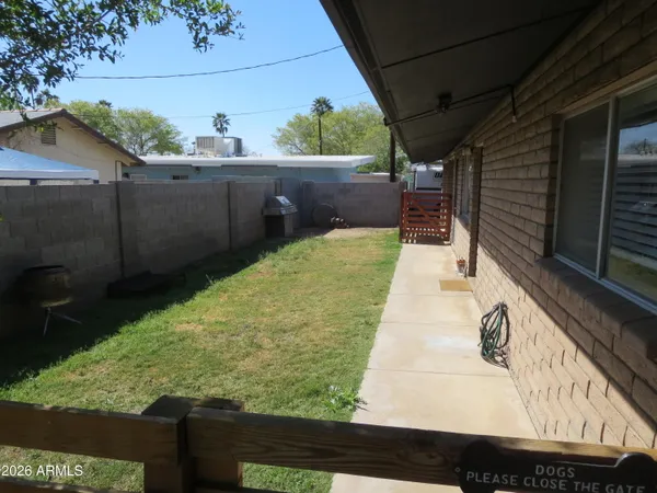 a kitchen with stainless steel appliances a sink dishwasher a refrigerator and a stove with wooden floor