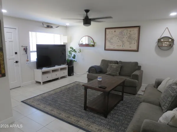 a bedroom with bed tv and window