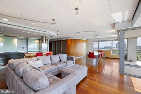 a bedroom with a bed couch and a large window