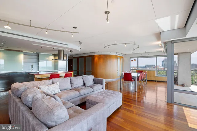 a bedroom with a bed couch and a large window