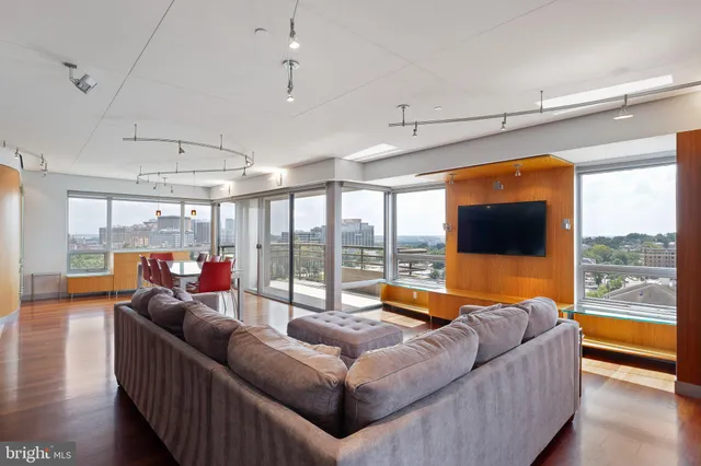 a bedroom with furniture and large window