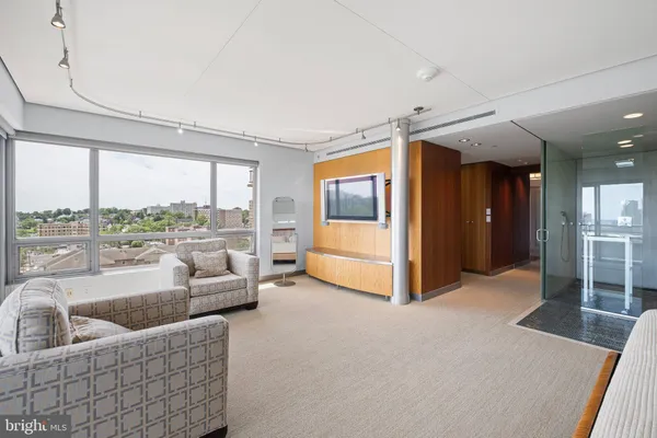 a view of a room with wooden floor and cabinet