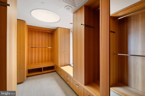 a living room with furniture and large windows