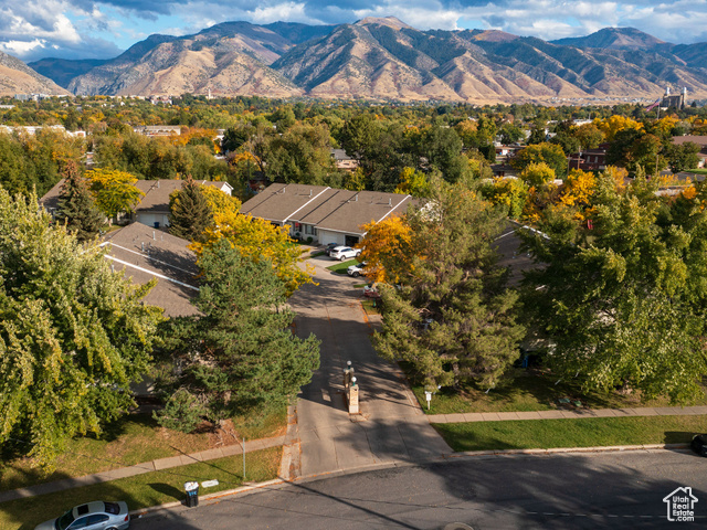 190 West 700 North Logan, UT 84321 - Photo 2 of 51 Aerial view of residential area with a mountain backdrop and a tree filled landscape