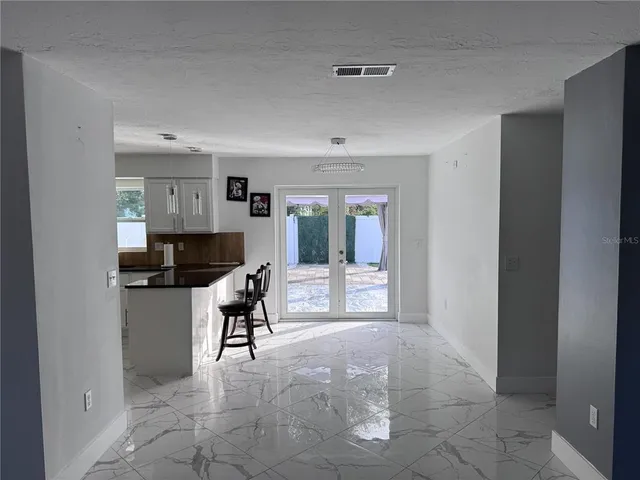 a living room with furniture and a piano