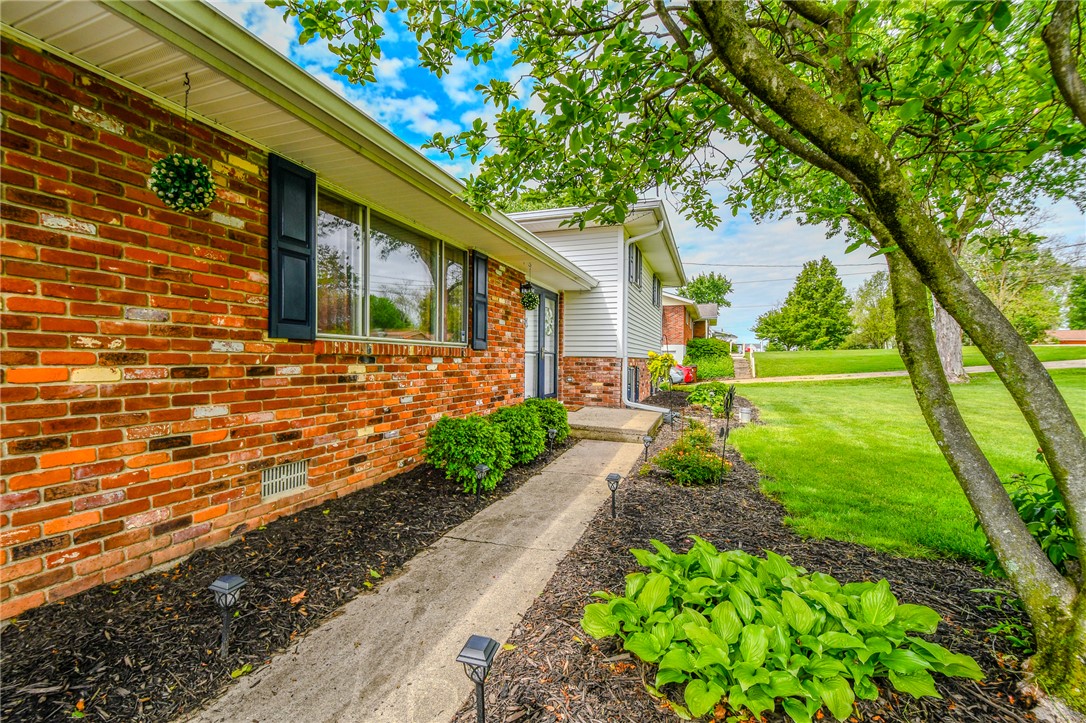 10833 Kendig Road Medway, OH 45341 - Photo 6 of 46 This charming home offers a welcoming facade with a well-maintained lawn and mature trees.