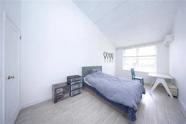 a bedroom with a bed and a window