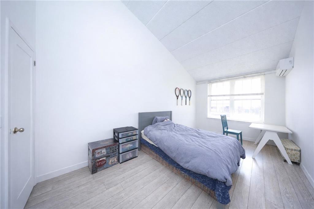 316 101st Street, Unit 41E Brooklyn, NY 11209 - Photo 12 of 26 a bedroom with a bed and a window