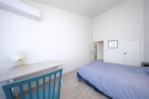 a bedroom with a bed and a table