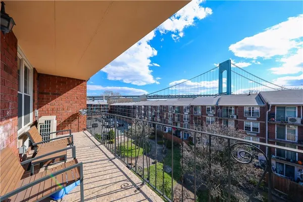 a view of a balcony with wooden floor
