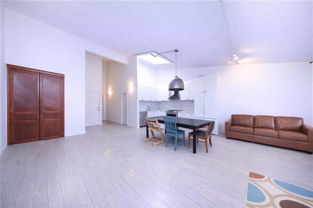 316 101st Street, Unit 41E Brooklyn, NY 11209 - Photo 4 of 26 a view of a livingroom with furniture and wooden floor