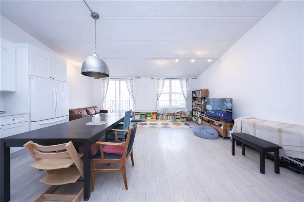 316 101st Street, Unit 41E Brooklyn, NY 11209 - Photo 5 of 26 a living room with furniture and a table