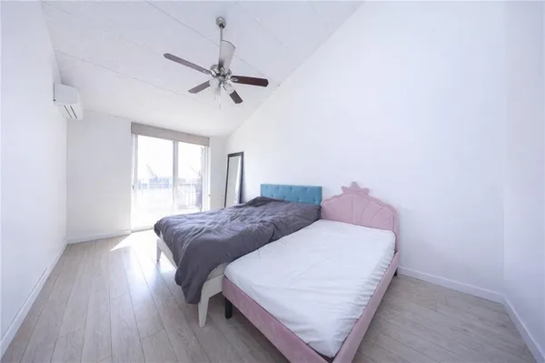 a bedroom with a bed and window