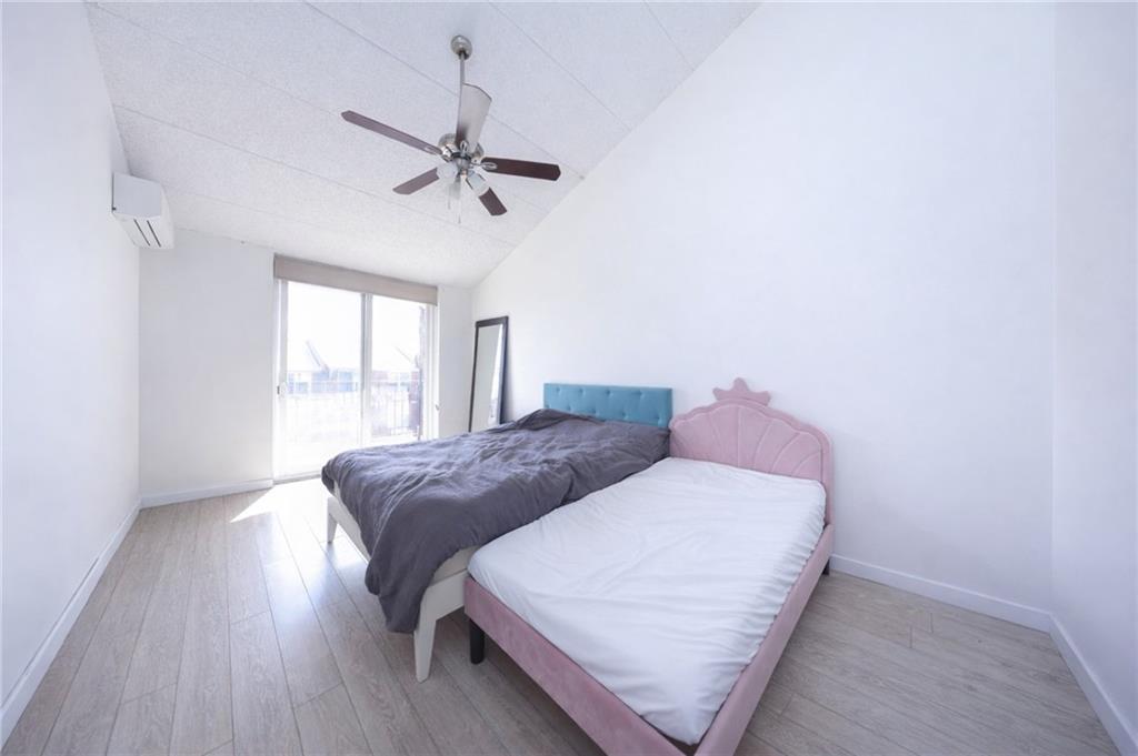 316 101st Street, Unit 41E Brooklyn, NY 11209 - Photo 9 of 26 a bedroom with a bed and window