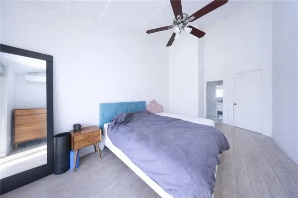 a bedroom with a bed and a shower