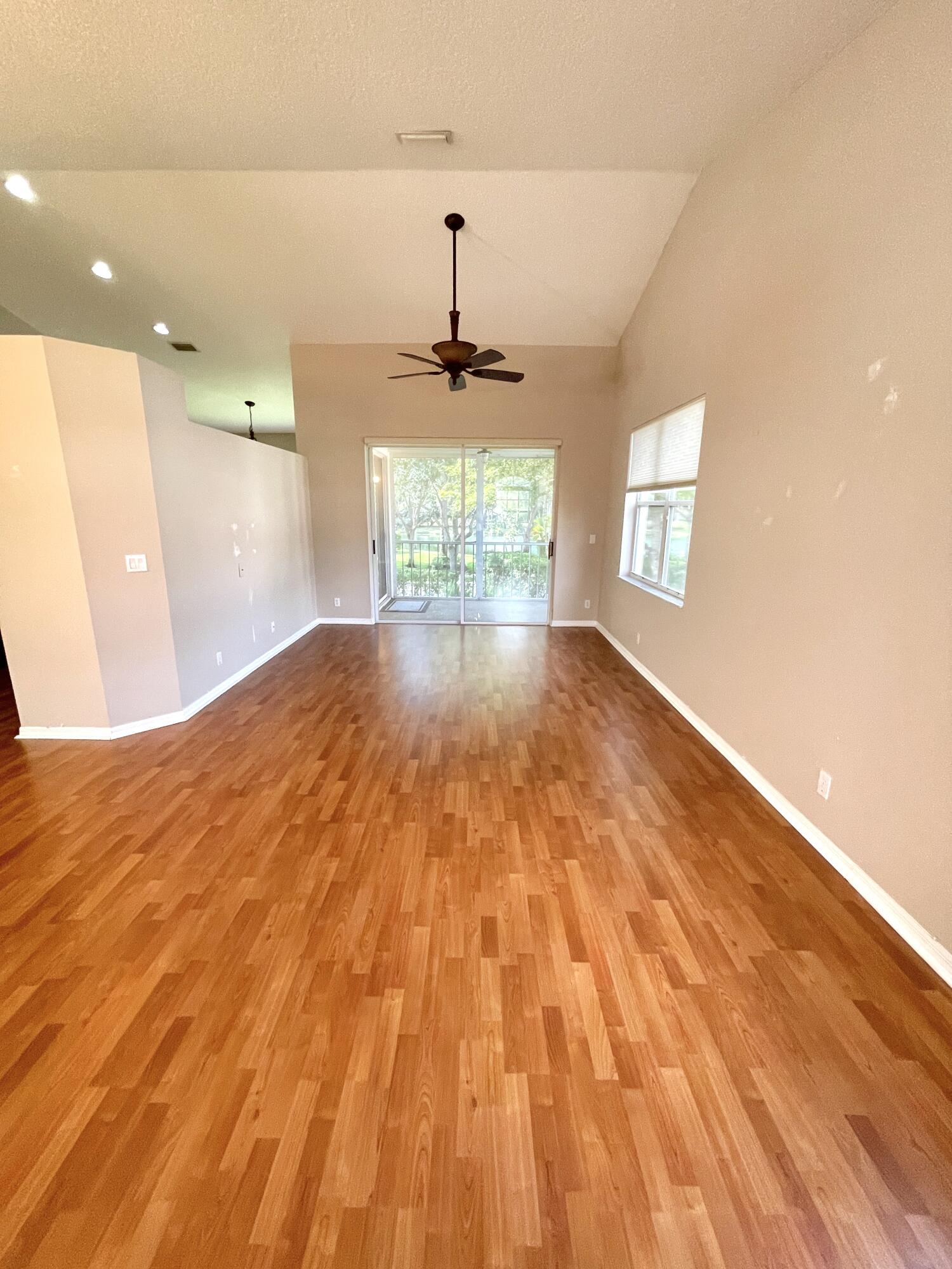 8550 Vía Romana, Unit 2 Boca Raton, FL 33496 - Photo 8 of 28 a view of empty room with wooden floor and fan