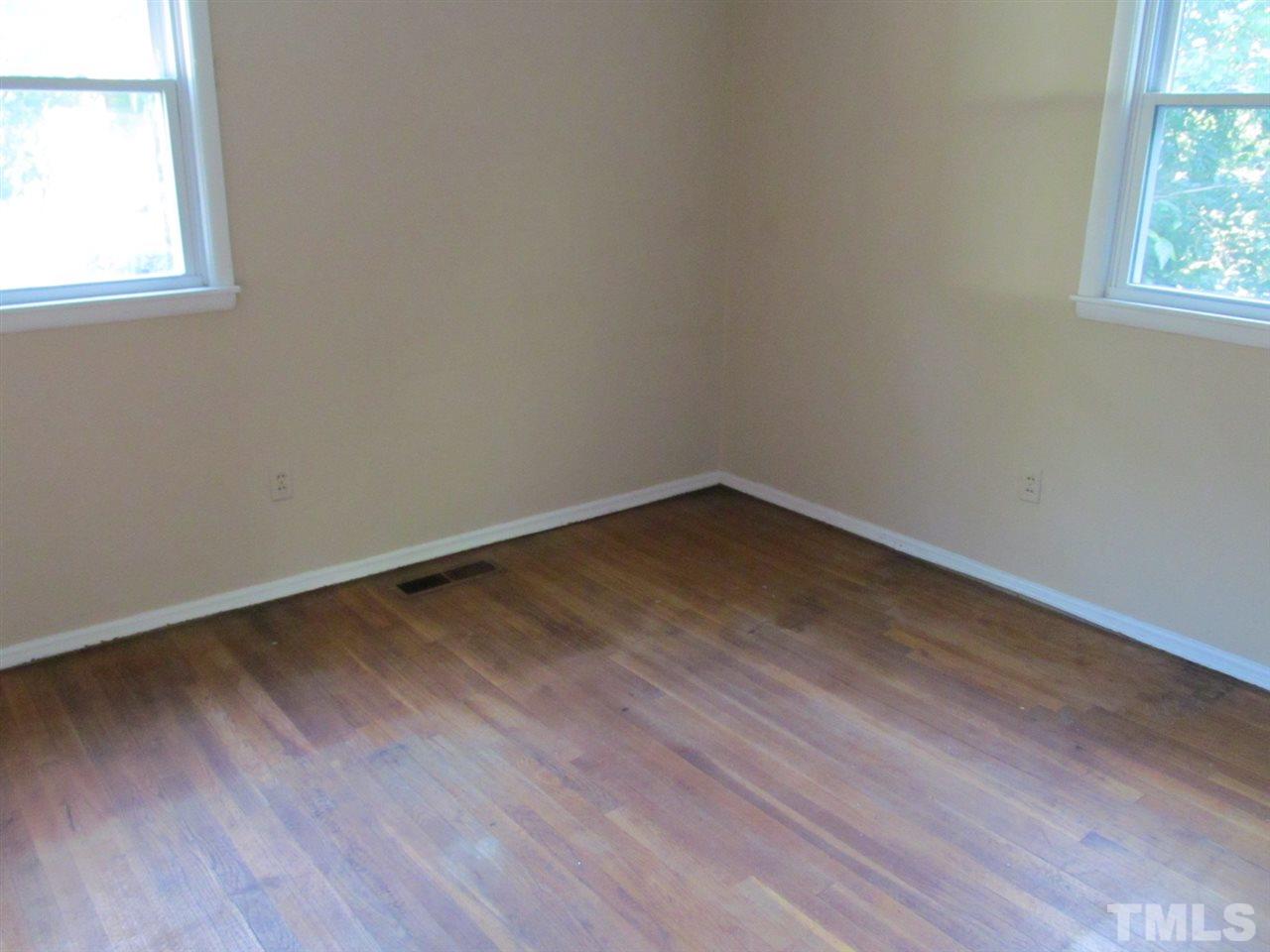 3417 Cheyenne Road Raleigh, NC 27609 - Photo 12 of 25 an empty room with wooden floor and windows
