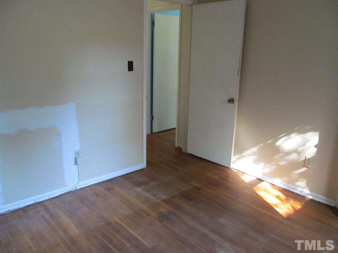 3417 Cheyenne Road Raleigh, NC 27609 - Photo 13 of 25 a view of an empty room with wooden floor and a window