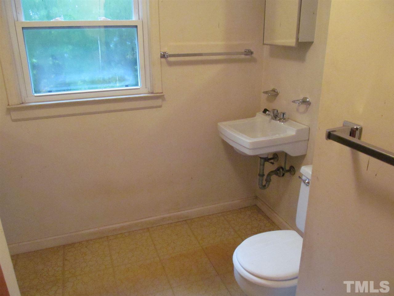 3417 Cheyenne Road Raleigh, NC 27609 - Photo 17 of 25 a white toilet sitting next to a bathroom sink